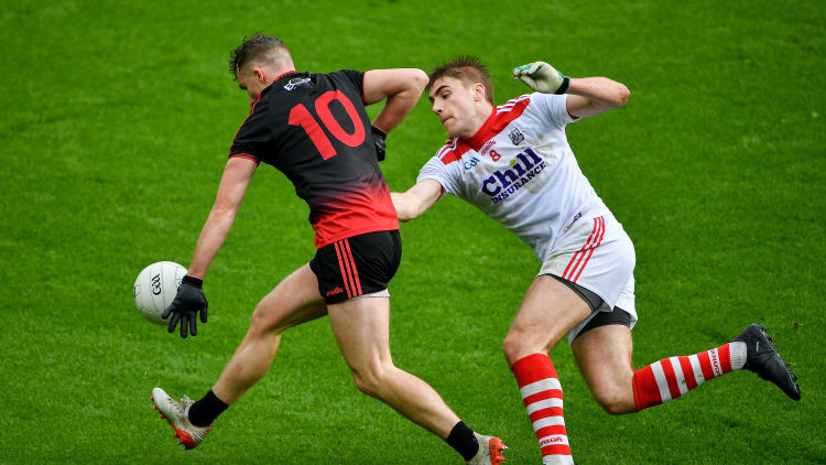 Barry O'Hagan, Down, and Ian Maguire, Cork, during the Allianz Football League Division Three clash at Páirc Uí Chaoimh.