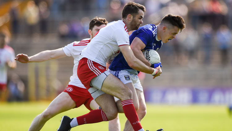 Dara McVeety of Cavan is tackled by Ronan McNamee,Tyrone, during the All-Ireland Senior Football Championship Round 4 Qualifier tie at St. Tiernach's Park in Clones.
