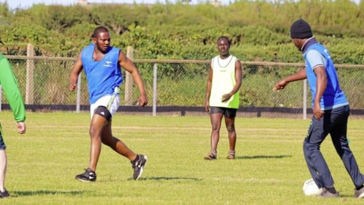 The Ghanaian fisherman pictured learning the skills of Gaelic Football at Ardglass GAC.