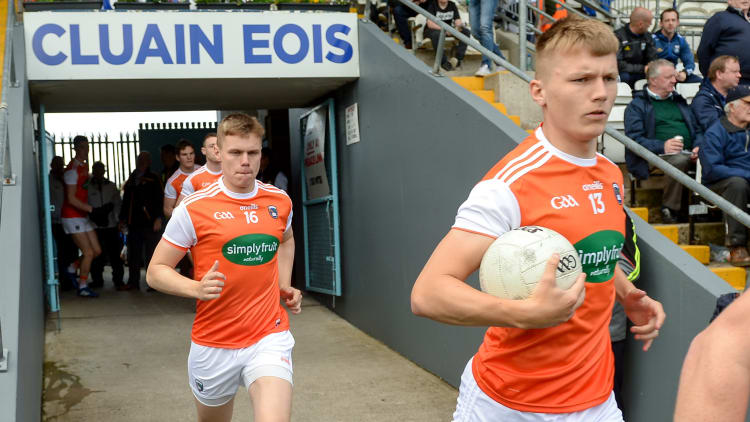 Rian O’Neill of Armagh runs on to the field in front of his brother Oisin O'Neill before the 2019 Ulster GAA Football Senior Championship Semi-Final Replay match between Cavan and Armagh at St Tiarnach's Park in Clones, Monaghan.