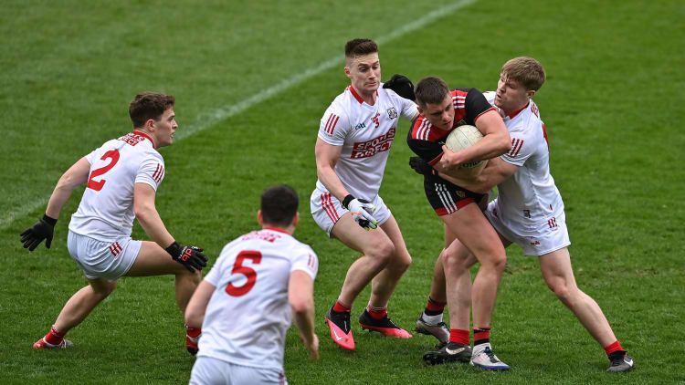 Pat Havern of Down under pressure from Cork defenders, from left, Kevin O’Donovan, Rory Maguire, Kevin Flahive and John Cooper during the Allianz Football League Division 2 match between Cork and Down at Páirc Uí Chaoimh in Cork.
