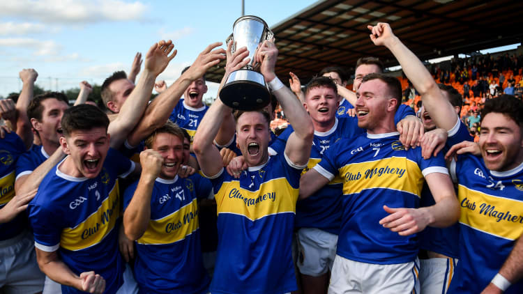 David Lavery of Maghery Seán MacDiarmada, centre, lifts the cup and celebrates with team-mates following the Armagh County Senior Football Championship Final match between Crossmaglen Rangers and Maghery Seán MacDiarmada at the Athletic Grounds in Armagh.