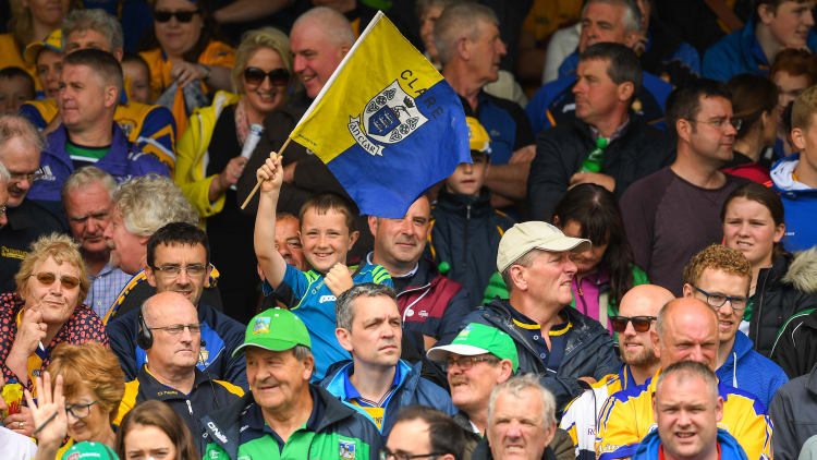 A young Clare supporter waves his flag before the 2018 Munster GAA Hurling Senior Championship Round 5 match between Clare and Limerick at Cusack Park in Ennis, Clare.
