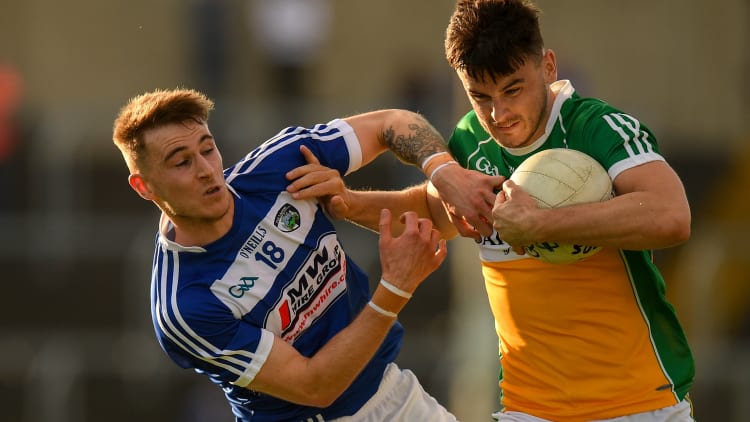 Eoin Carroll of Offaly is tackled by Trevor Collins of Laois during the GAA Football All-Ireland Senior Championship Round 3 match between Laois and Offaly at O'Moore Park in Portlaoise, Laois.