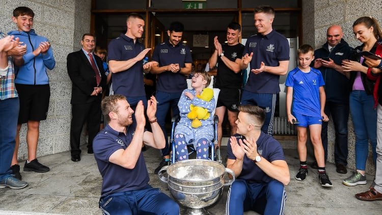 Mary Rose O'Connell, age 12, from Co Waterford pictured with Dublin players, back row, from left, Con O'Callaghan, Cian O'Sullivan, Brian Howard, Rob McDaid and front row Jack McCaffrey, left, and Eoin Murchan and the Sam Maguire Cup on a visit by the All-Ireland Senior Football Champions to the Children's Health Ireland at Crumlin in Dublin.