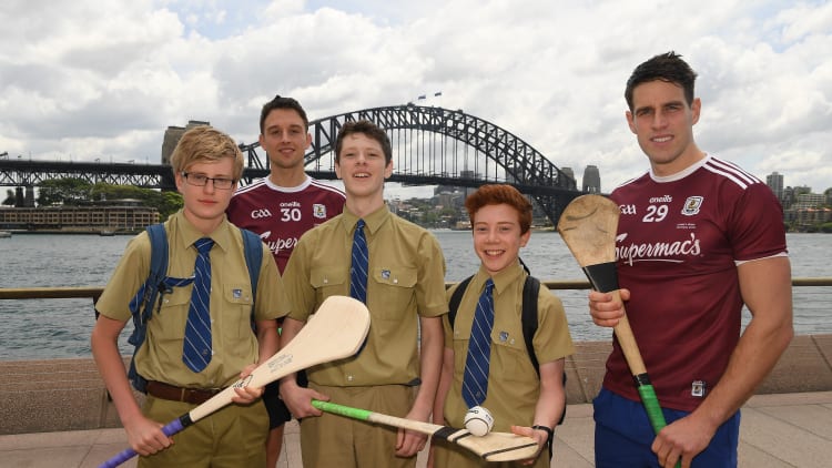 Gearóid McInerney, right, and Niall Burke, Galway, with Padraig Frewen, Finn Lavelle, and Aidan Collins, pupils of the local St Ignatius College, in Sydney Harbour prior to the Wild Geese Cup in Sydney. Circular Quay, New South Wales, Australia.