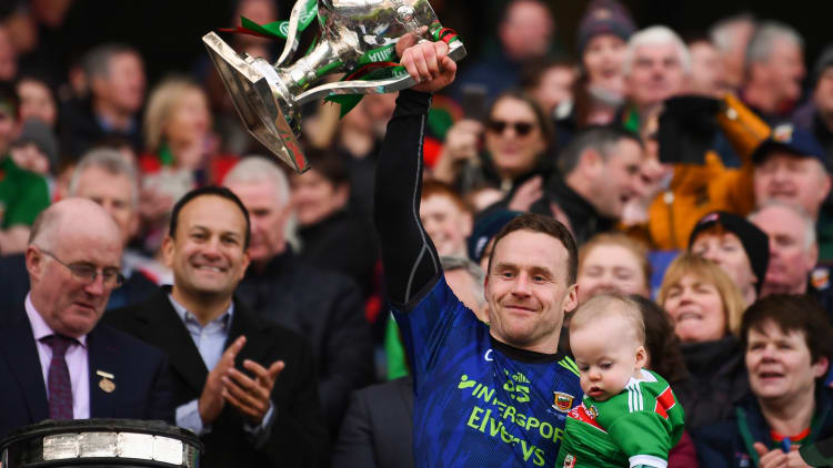Andy Moran lifts the Cup with his son Ollie after Mayo's victory over Kerry in the Allianz Football League Division 1 Final.