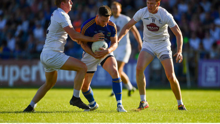 Longford's Mickey Quinn surrounded by Keith and Paul Cribbin at Glennon Brothers Pearse Park.